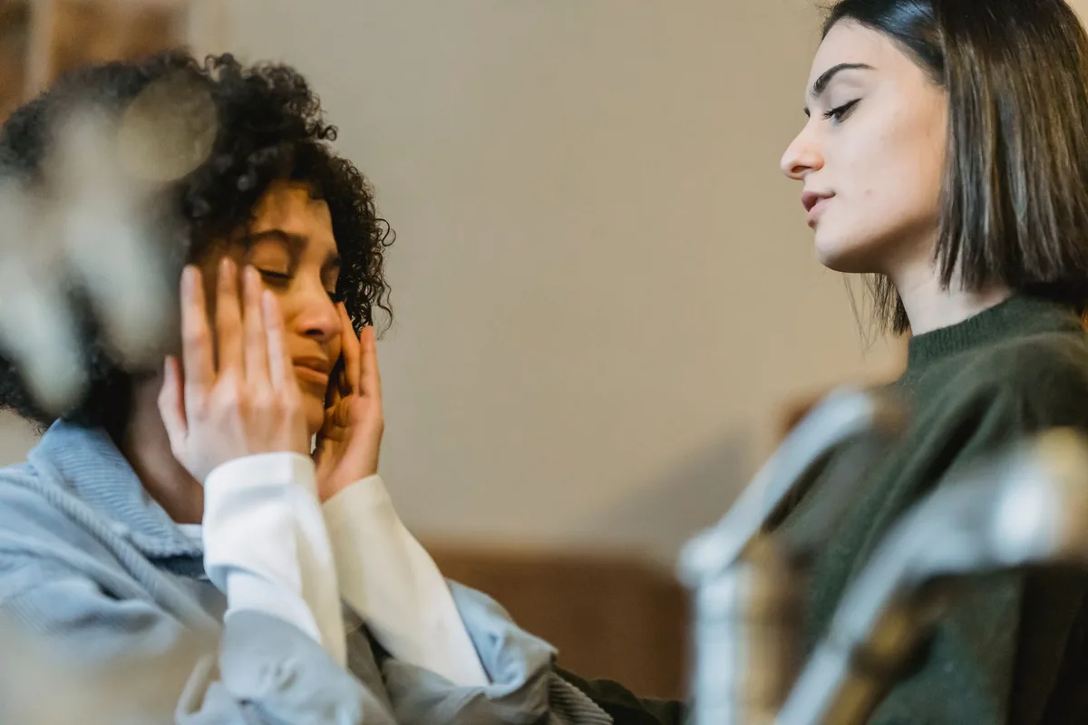 Deux personnes en conversation empathique, l'une écoutant l'autre avec bienveillance.