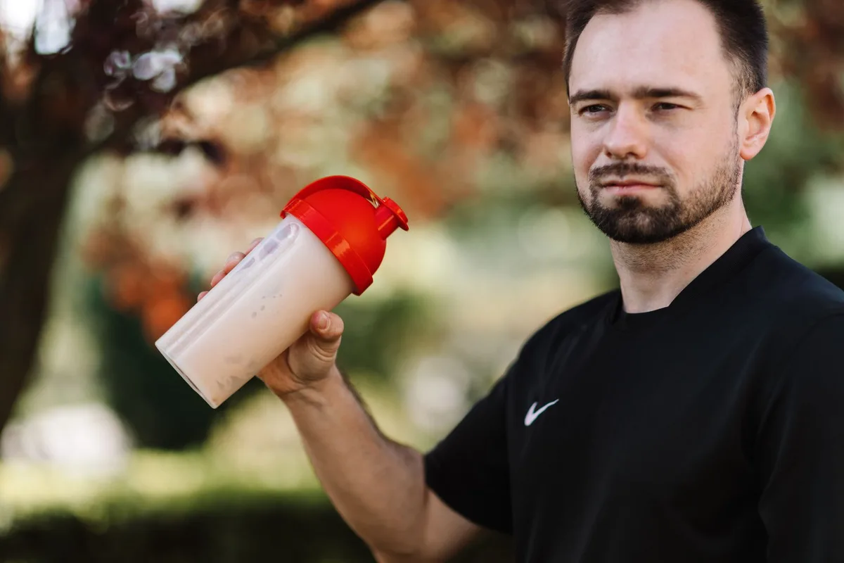 Poudre de protéines et glucides mélangés dans un shaker